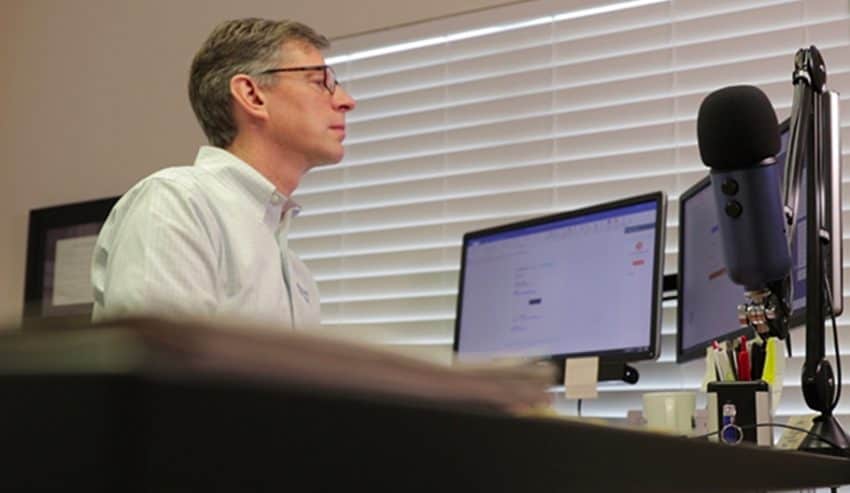 man sitting at computer